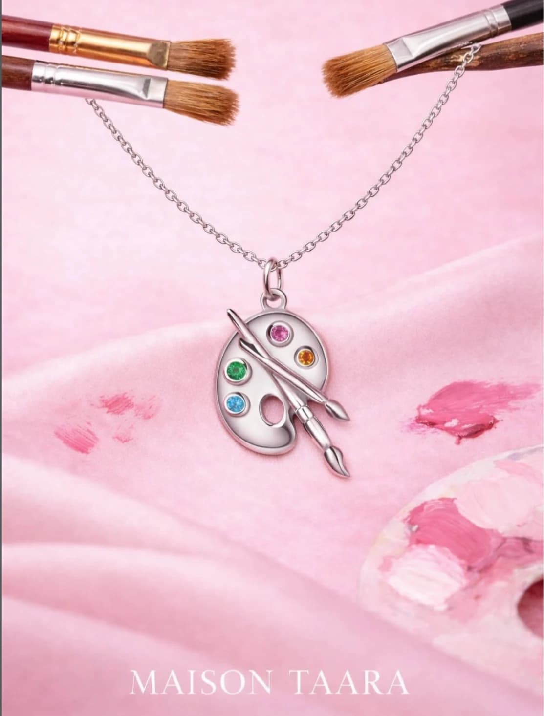 Artist palette pendant on blush fabric for Maison Taara World Art Day.