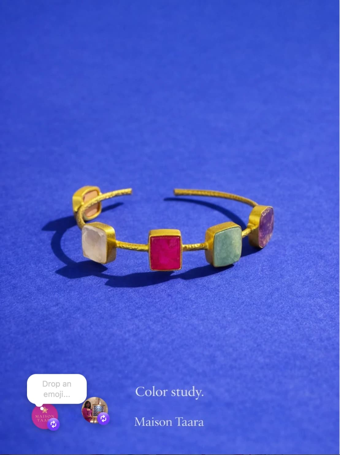 Maison Taara cuff bracelet with bright gemstone tones on blue.