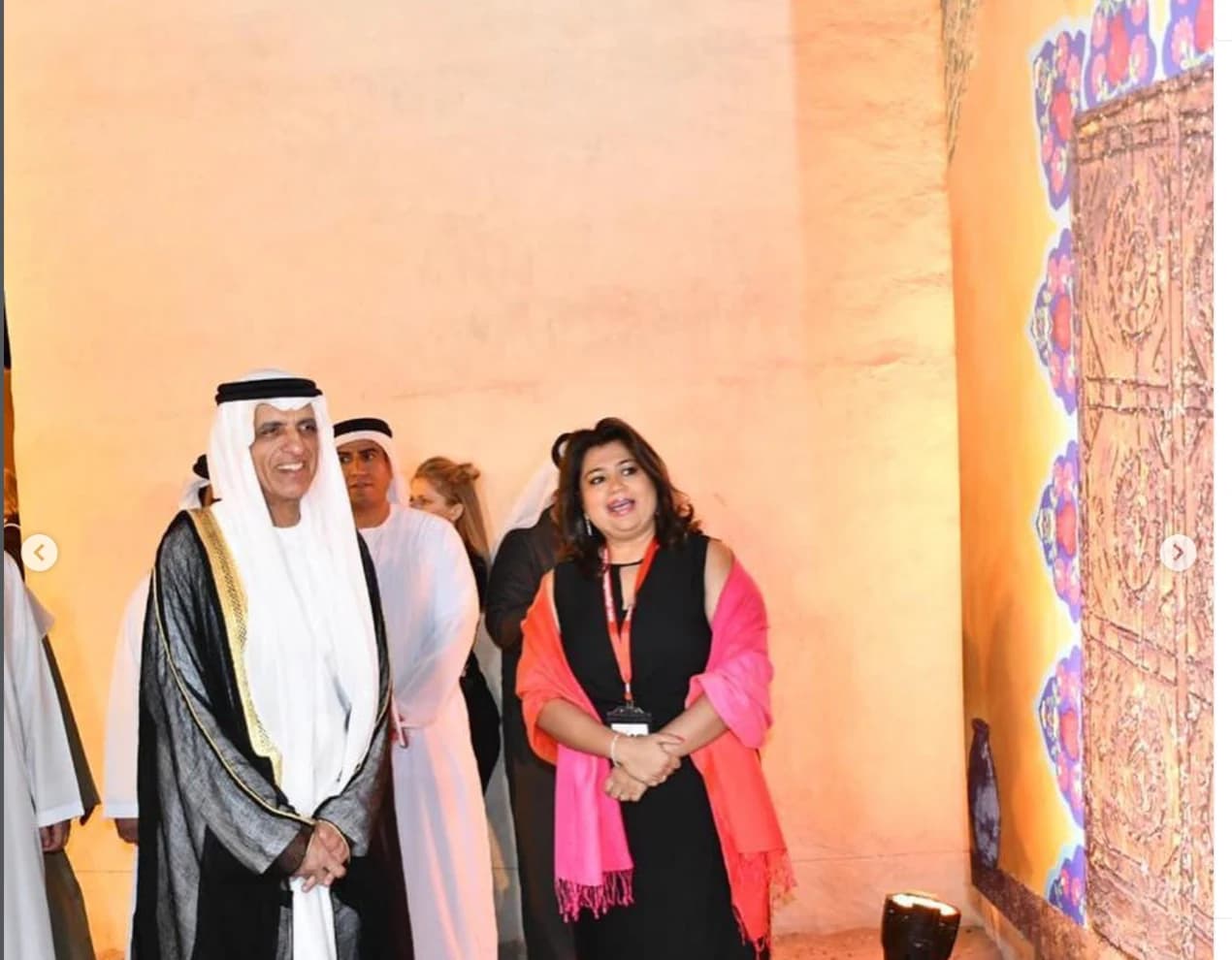 Cheshta Roy Sarkar standing beside her artwork at Ras Al Khaimah Fine Arts Festival 2019.